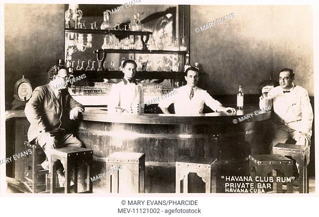 The private bar at Havana Club Rum, Havana, Cuba, with two bartenders and two customers