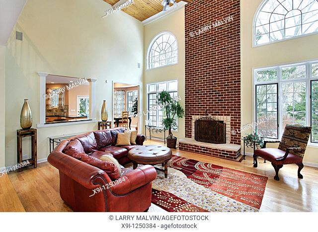 Family room in suburban home with two story brick fireplace