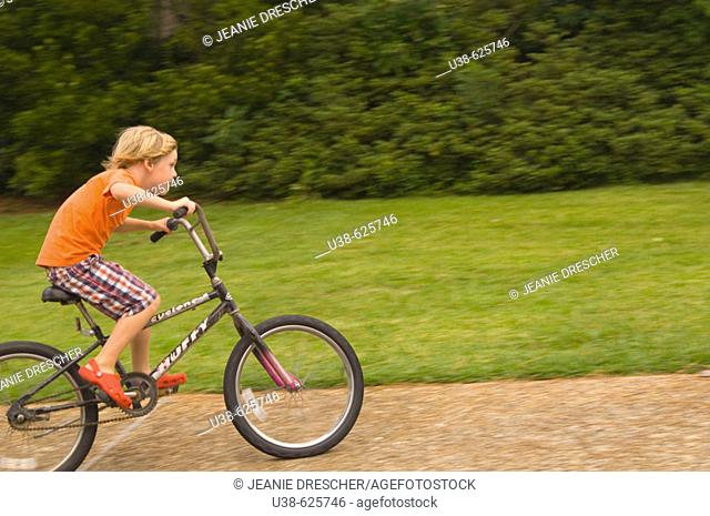 6 year old boy riding a bike very fast. Point Harbor, North Carolina. USA
