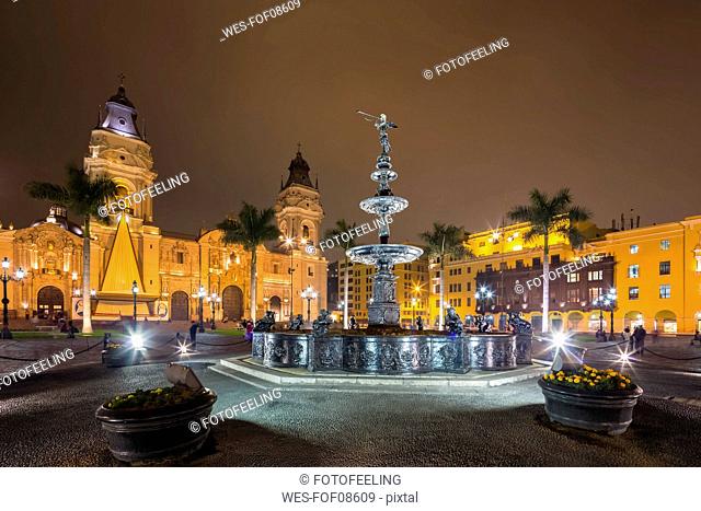 Peru, Lima, Plaza de Armas, Cathedral of Lima and fountain at night