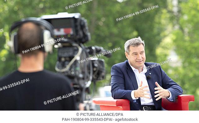 04 August 2019, Berlin: The Bavarian Prime Minister Markus Söder (CSU) sits on the terrace of the Marie-Elisabeth-Lüders-Haus during the ARD summer interview
