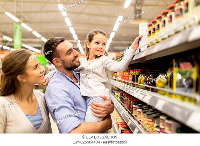 sale, shopping, consumerism and people concept - happy family with child buying food at grocery store or supermarket