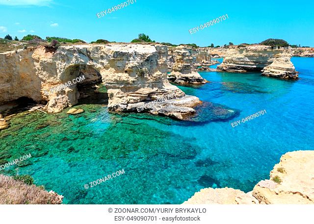 Picturesque seascape with cliffs, rocky arch and stacks (faraglioni), at Torre Sant Andrea, Salento sea coast, Puglia, Italy