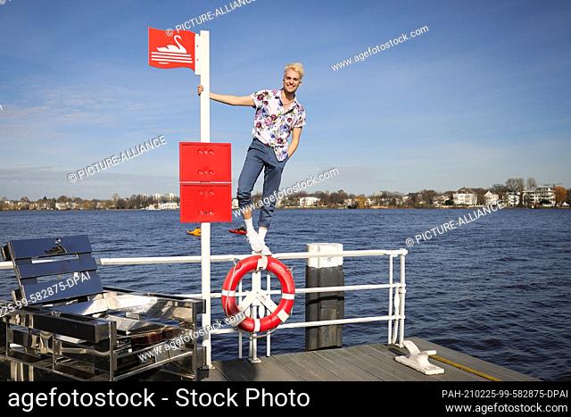 24 February 2021, Hamburg: Jendrik Sigwart, singer and musical performer, stands on a railing during a photo session at the Alster