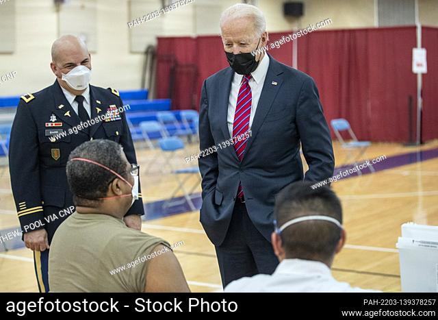 US President Joe Biden is is escorted by the Director of Walter Reed National Military Medical Center Colonel Andrew Barr (L) on a tour of a COVID-19 v...