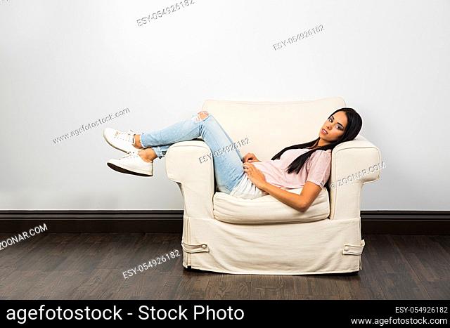 Twenty something woman laying on a couch