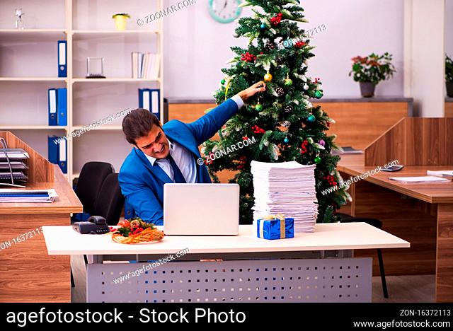 Young employee working in the office at Chrismas