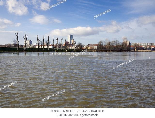 Ripples and waves form on a side arm of the Oder river in Slubice, Poland, 05 February 2013. The skyline of Frankfurt/Oder is pictured in the background