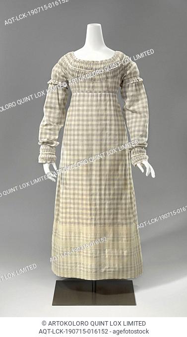 Gown Dress in white with blue checkered cotton, with long sleeves decorated with white rolled seams, the neck and cuffs with strongly wrinkled puffing seams...