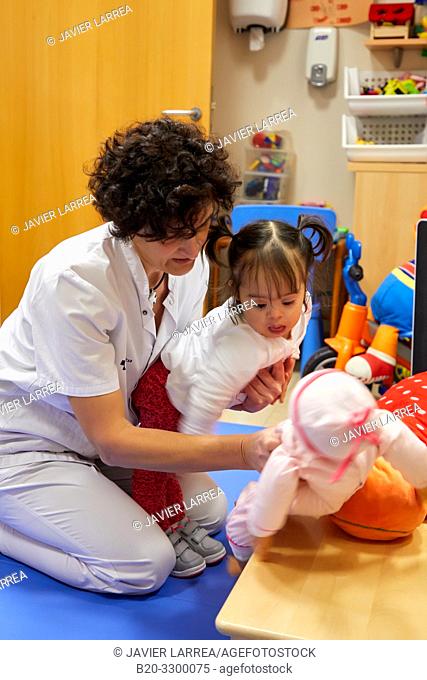 Physiotherapist teaching a girl with Down syndrome to stand up, Rehabilitation, Amara Berri Health Center building, Donostia, San Sebastian, Gipuzkoa