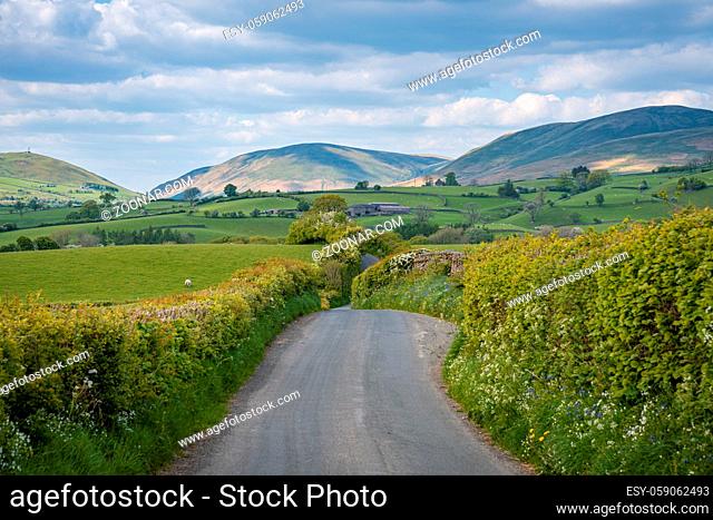 Rural road in the Yorkshire Dales landscape between Sedbergh and Beck Foot, Cumbria, England, UK