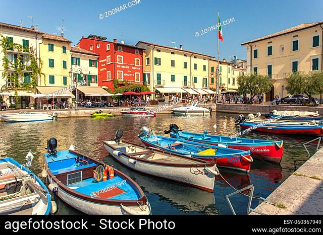 LAZISE, ITALY 16 SEPTEMBER 2020: Dogana Veneta and Porticciolo in Lazise, in Italy with colored boats
