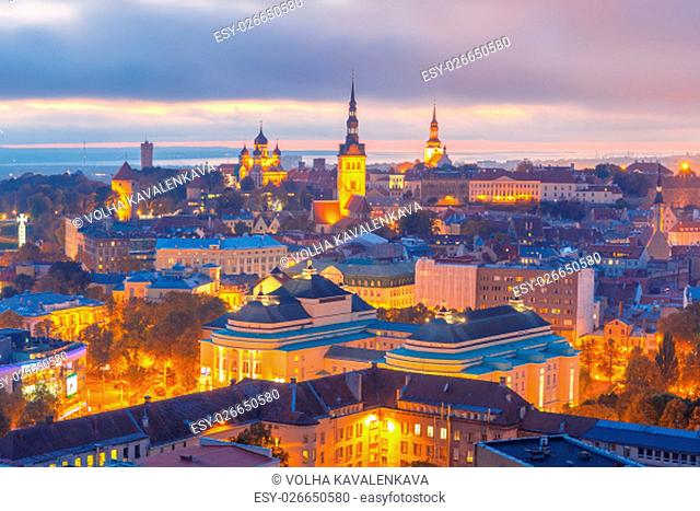 Aerial cityscape with Medieval Old Town illuminated at sunset with Saint Nicholas Church, Cathedral Church of Saint Mary and Alexander Nevsky Cathedral in...