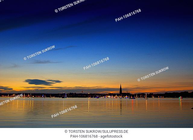 25.08.2017, The skyline of Schleswig with a fantastic evening sky on a beautiful late summer evening. On the water lighted sailboats drive at the 5th aftert of...