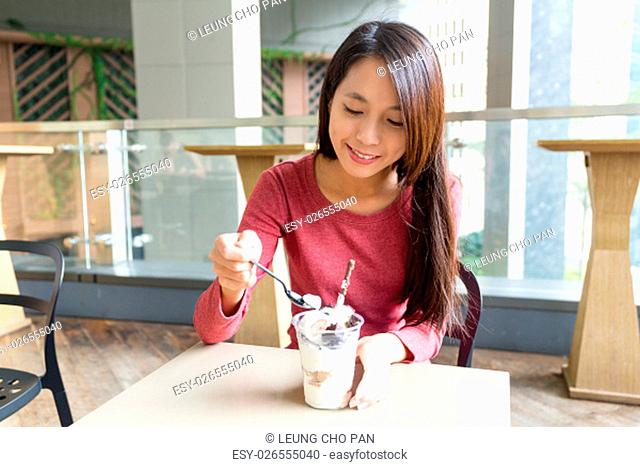 Woman enjoy her ice cream in cafe