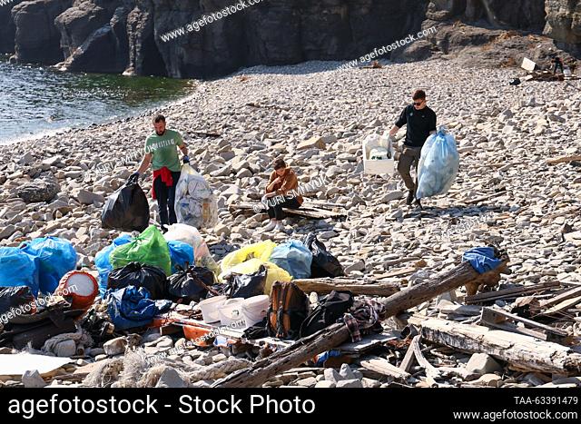 RUSSIA, VLADIVOSTOK - OCTOBER 15, 2023: Volunteers take part in a clean-up event to collect marine debris by a lighthouse on the Basargin Cape in the Eastern...