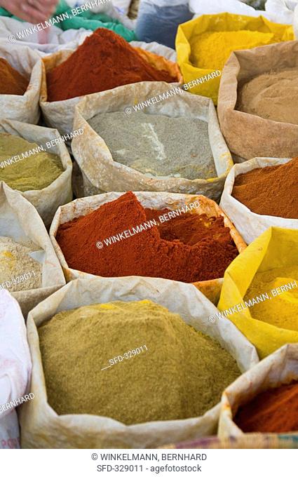 Various spices in sacks at a market in Essaouira