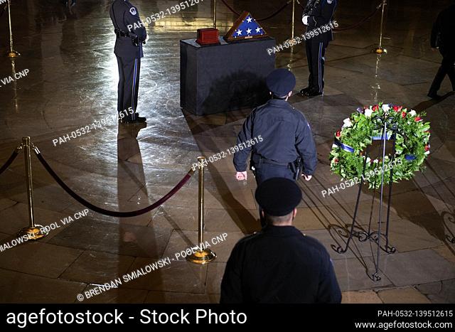 Members of the Capitol Police and others pay their respects before the remains of Capitol Police officer Brian Sicknick lay in honor in the Rotunda of the US...