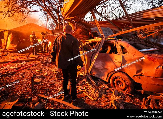 RUSSIA, DONETSK - NOVEMBER 7, 2023: A man stands before a car wrecked by a Ukrainian military strike, in Budyonnovsky District. Dmitry Yagodkin/TASS