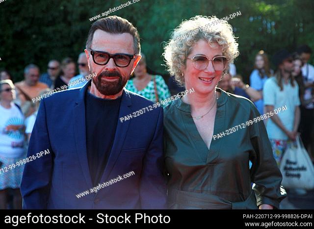 12 July 2022, Sweden, Stockholm: Abba star Björn Ulvaeus arrives with his partner Christina Sas for the premiere of the circus musical he produced