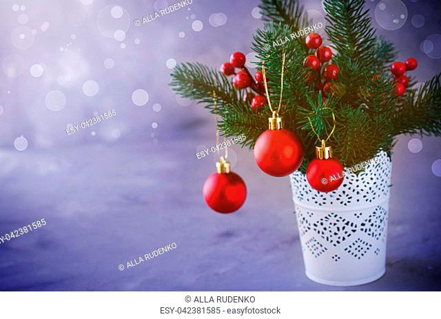Christmas background with xmas fir branches and decorations in the snow atmosphere. Christmas greeting postcard. Toned, snow effect