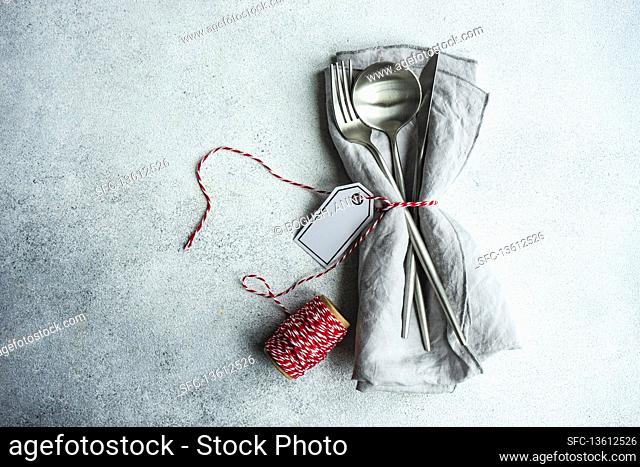 Festive cutlery set for Christmas holiday dinner on concrete table