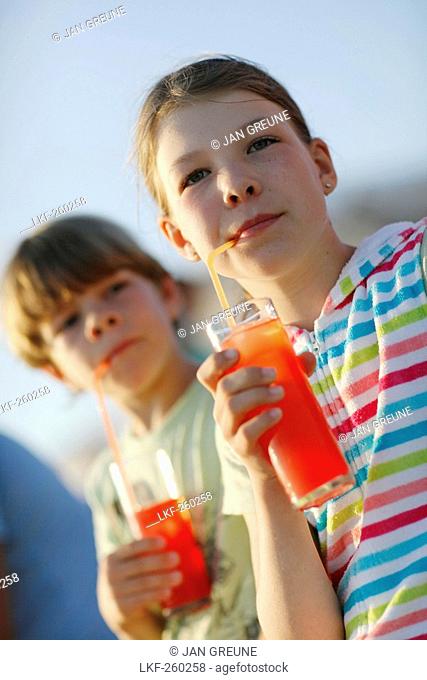 Girl and boy with fruit Juice, Formentera, Balearic Islands, Spain