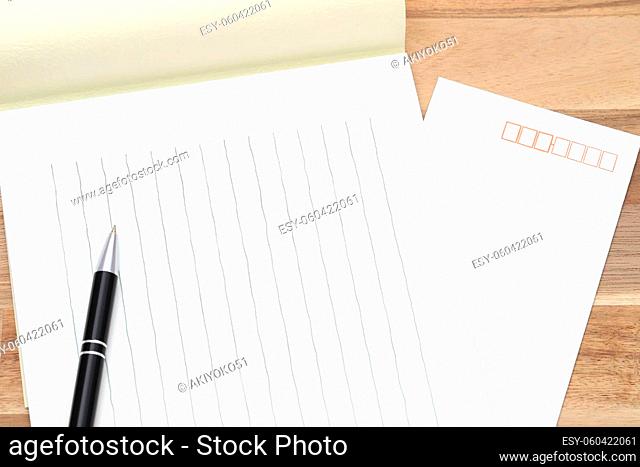 Japanese writing letter paper with ballpoint pen on wooden background