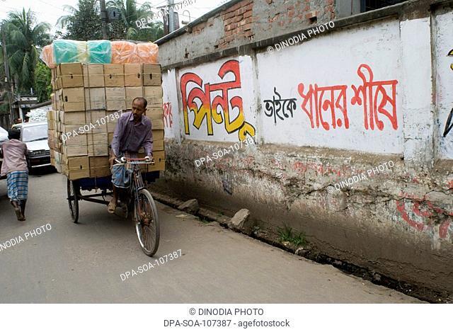 Cycle  Rickshaw Rider with Heavy load on street at Dhaka ; Bangladesh