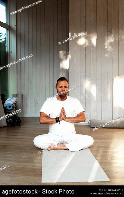 Man practicing yoga in studio