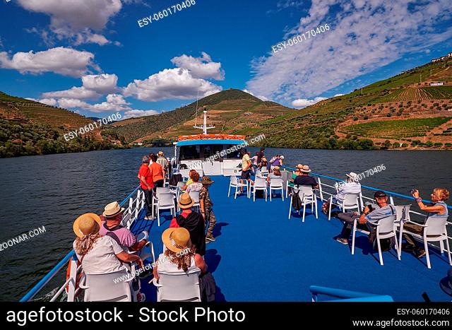 View from the Cruise Boat Open Deck in Douro River Valley - Port Wine Region with Farms Terraces Carved in Mountains, Portugal