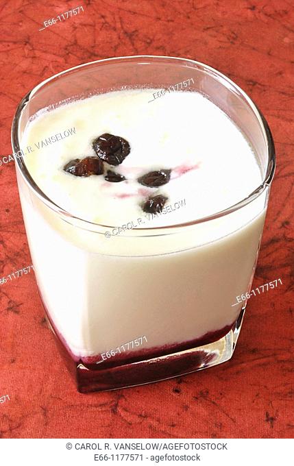 glass of kefir lactobacillas caucasicus is also known as laban, doogh, lassi, kumis  Picture shows a glass of kefir , with cherry syrup at the bottom of the...
