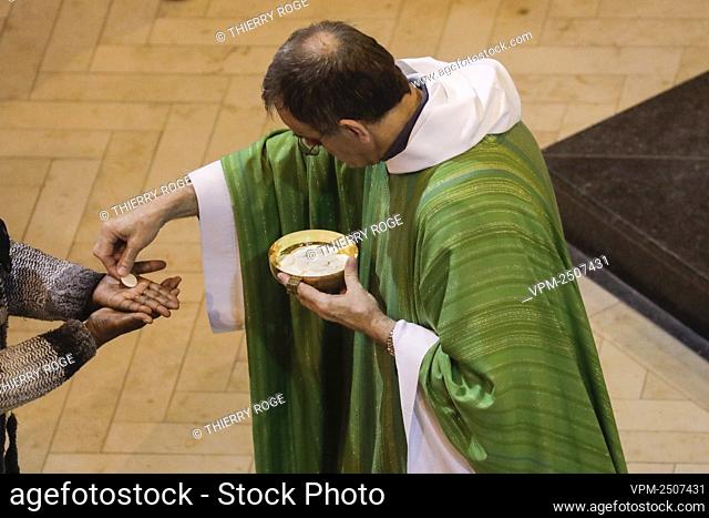 Illustration picture shows Father Marc Leroi during the nine o clock morning mass on a Monday, the first which can welcome hundred persons inside the Nationale...