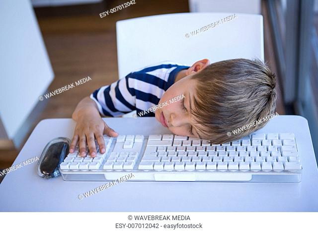 Little boy slipping on keyboard