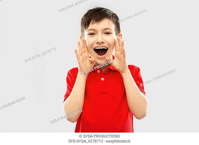 boy in red polo t-shirt shouting or calling