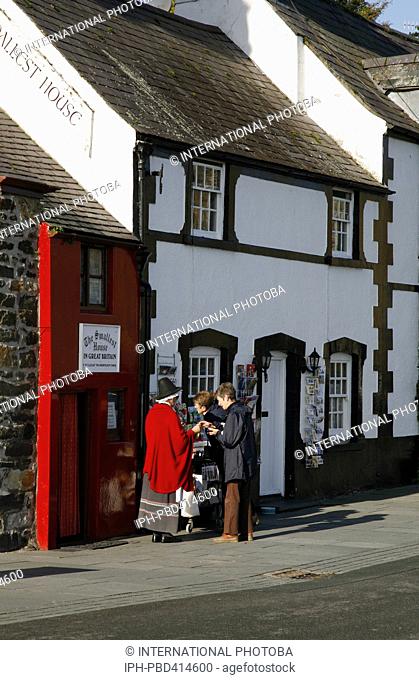 Wales Gwynedd Conwy Woman in Welsh National costume in front of the smallest house in Britain overlooking the River Conwy (Conway) estuary Peter Baker