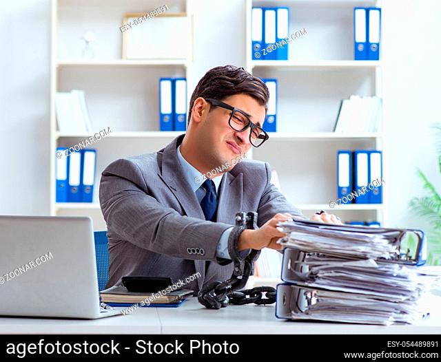 The busy employee chained to his office desk