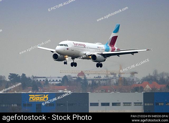 23 March 2021, Brandenburg, Schönefeld: An Airbus A 319 of the airline Eurowings with the identifier (hexcode) OE-LYX lands at Berlin Brandenburg ""Willy...