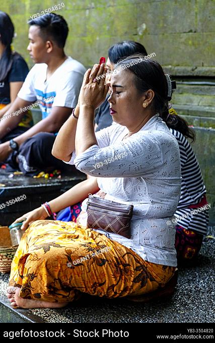 A Balinese Hindu Woman Praying At The Tirta Empul Water Temple, Bali, Indonesia