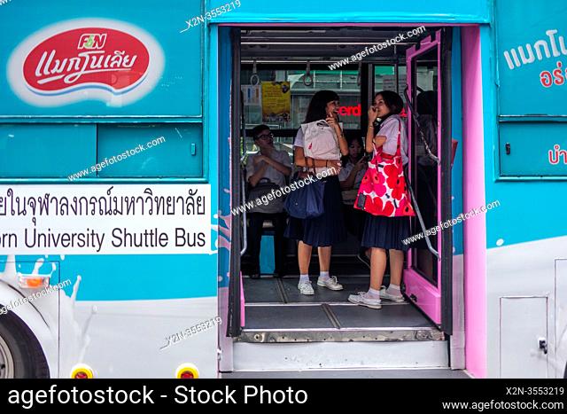 School girls on a university bus. Siam Square. Bangkok. Thailand