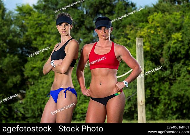 Two female athletes playing beach volleyball