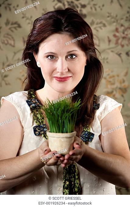 Woman with Small Pot of Green Grass