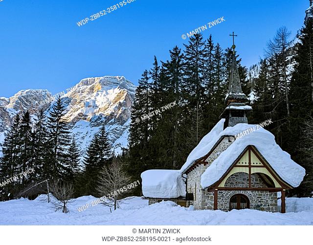 The Chapel at Lake Prager Wildsee (Lago di Braies) in the nature park Fanes Sennes Prags, part of UNESCO World Heritage Dolomites, during winter in deep snow