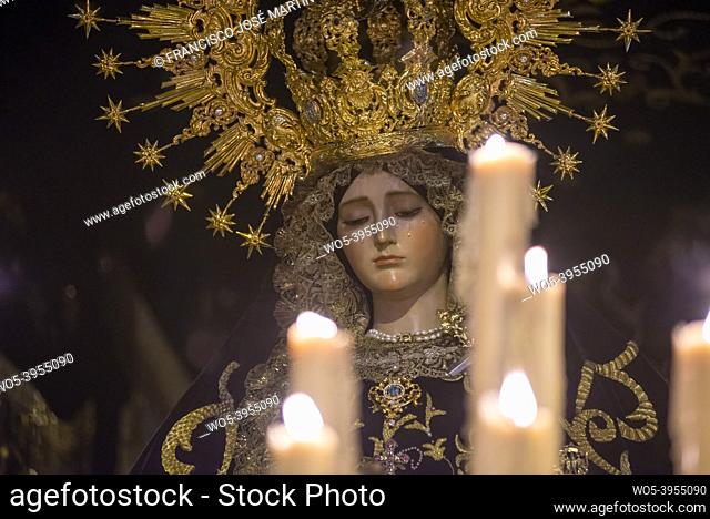 Detail of sculpture of virgin crying with candles lit in front, Easter, Holy Week, Spain