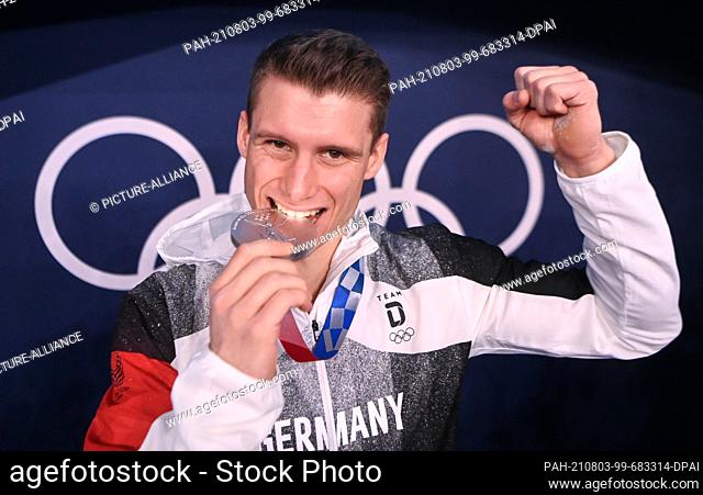 03 August 2021, Japan, Tokio: Gymnastics: Olympia, parallel bars, men, final at Ariake Gymnastics Centre. Lukas Dauser from Germany with silver medal after the...