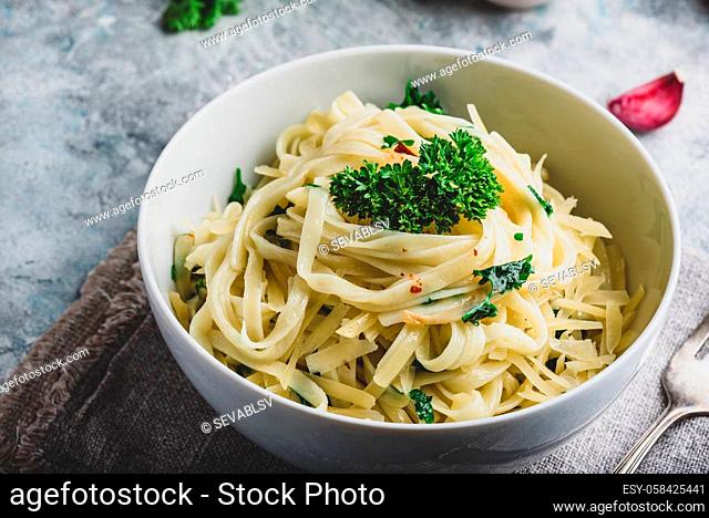 Easy lunch recipe. Linguine pasta with olive oil, garlic, fresh parsley and grated parmesan cheese