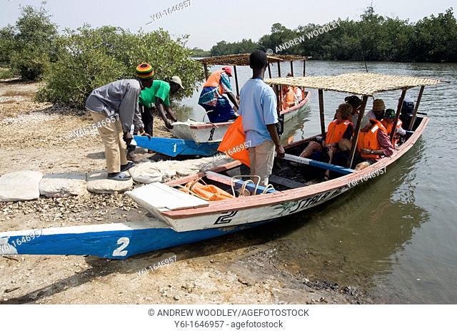 Bird watchers take boat trip on Allahein River in south of The Gambia