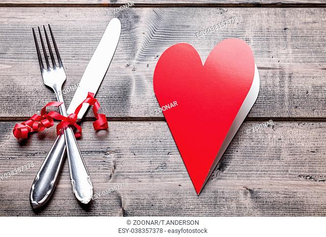 Romantic dinner set on rustic wooden background