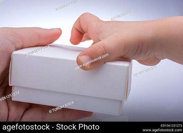 Hand holding a gift box in hand