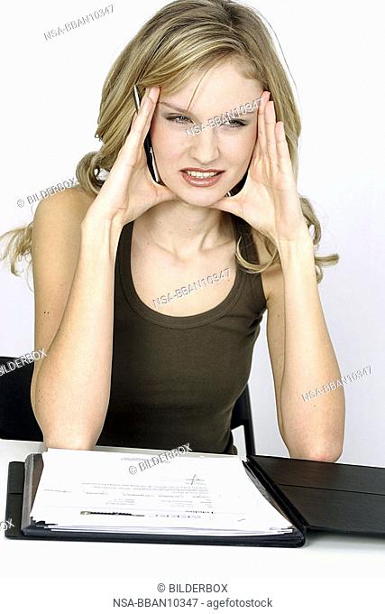 Woman with headache in the office